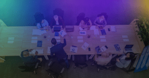 Overhead view of a buying group around a conference table. To manage buying groups, teams need to see every person involved.